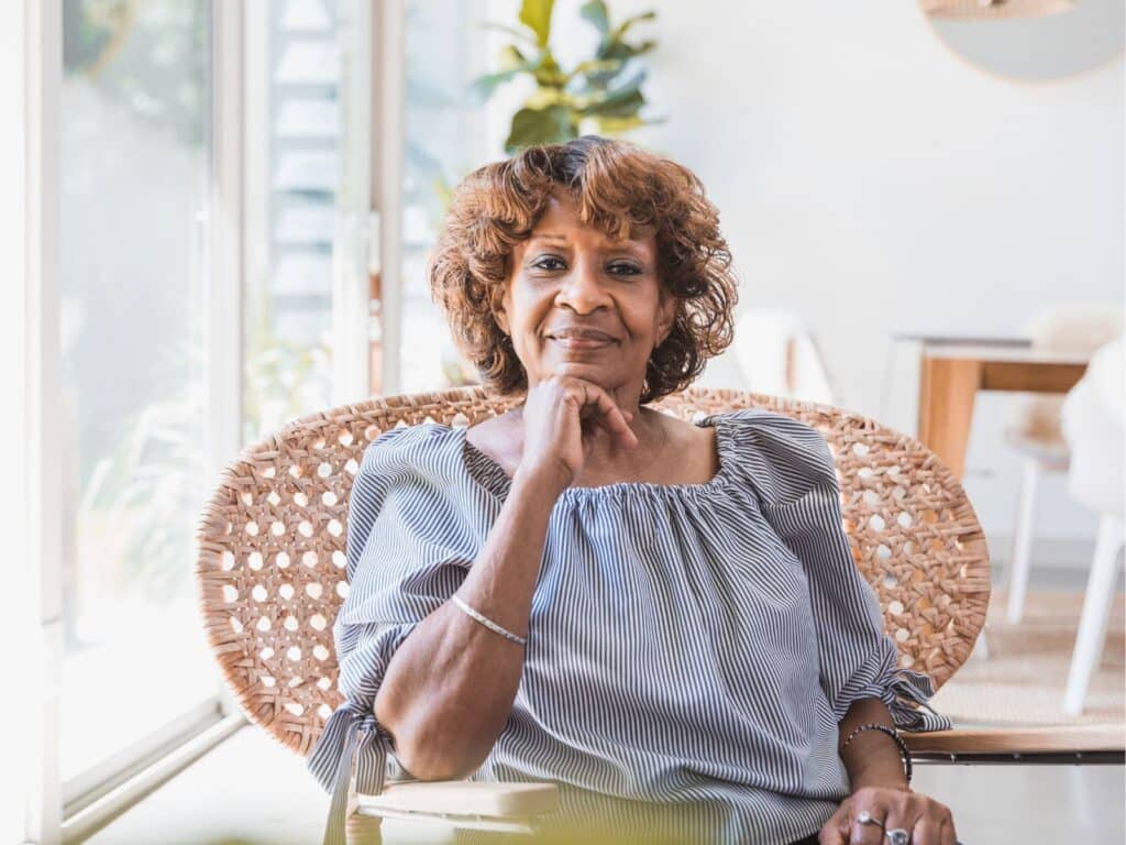 An older woman sitting comfortably in a chair
